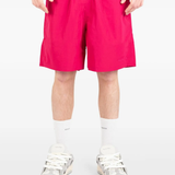 Pink shorts worn by a person, showing the shorts fit