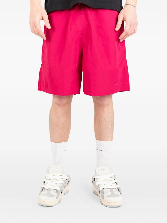 Pink shorts worn by a person, showing the shorts fit