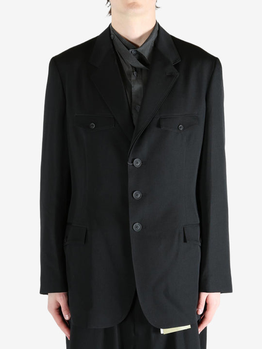 Black jacket worn by a person, showing the jacket's fit