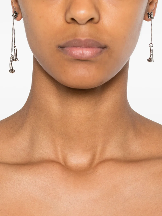 grey jewelry worn by a person, showing the jewelry  fit