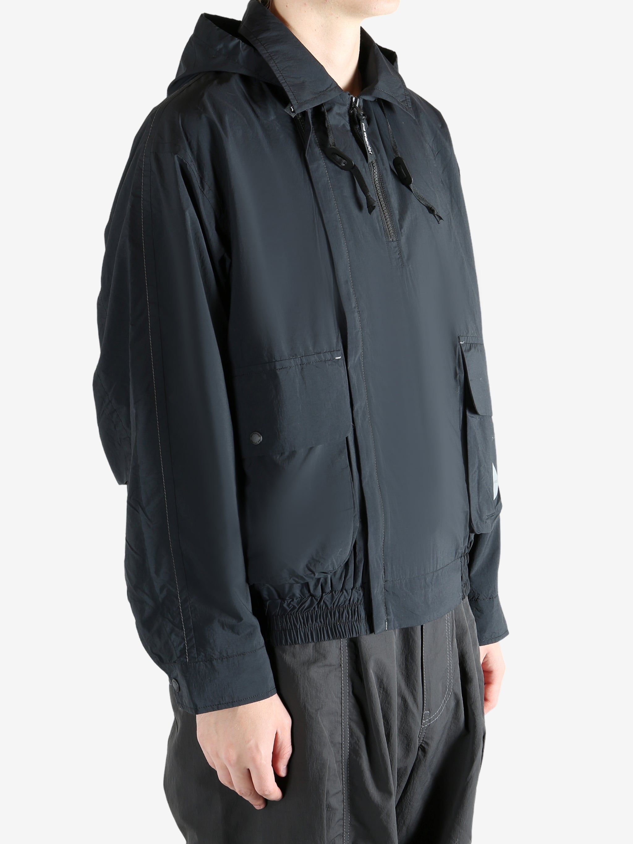 Black jacket worn by a person, showing the jacket fit