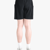 Black pants worn by a person, showing the pants fit
