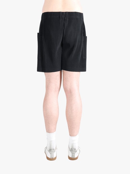 Black pants worn by a person, showing the pants fit