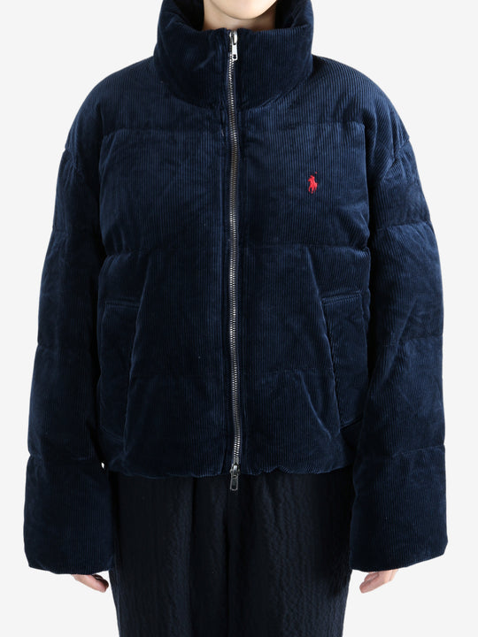 Navy coats worn by a person, showing the coats fit