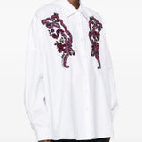 White shirt worn by a person, showing the shirt fit