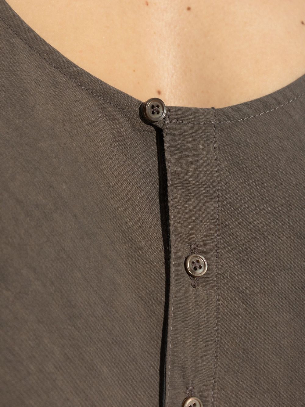 Close up of brown top, showing texture of the cotton fabric