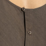 Close up of brown top, showing texture of the cotton fabric