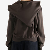 Brown hoodie worn by a person, showing the hoodie's fit