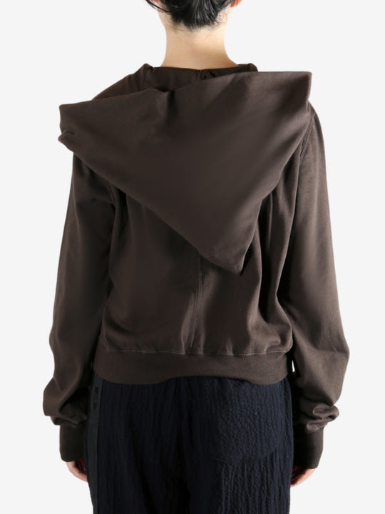 Brown hoodie worn by a person, showing the hoodie's fit