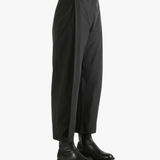 Black pants worn by a person, showing the pants fit