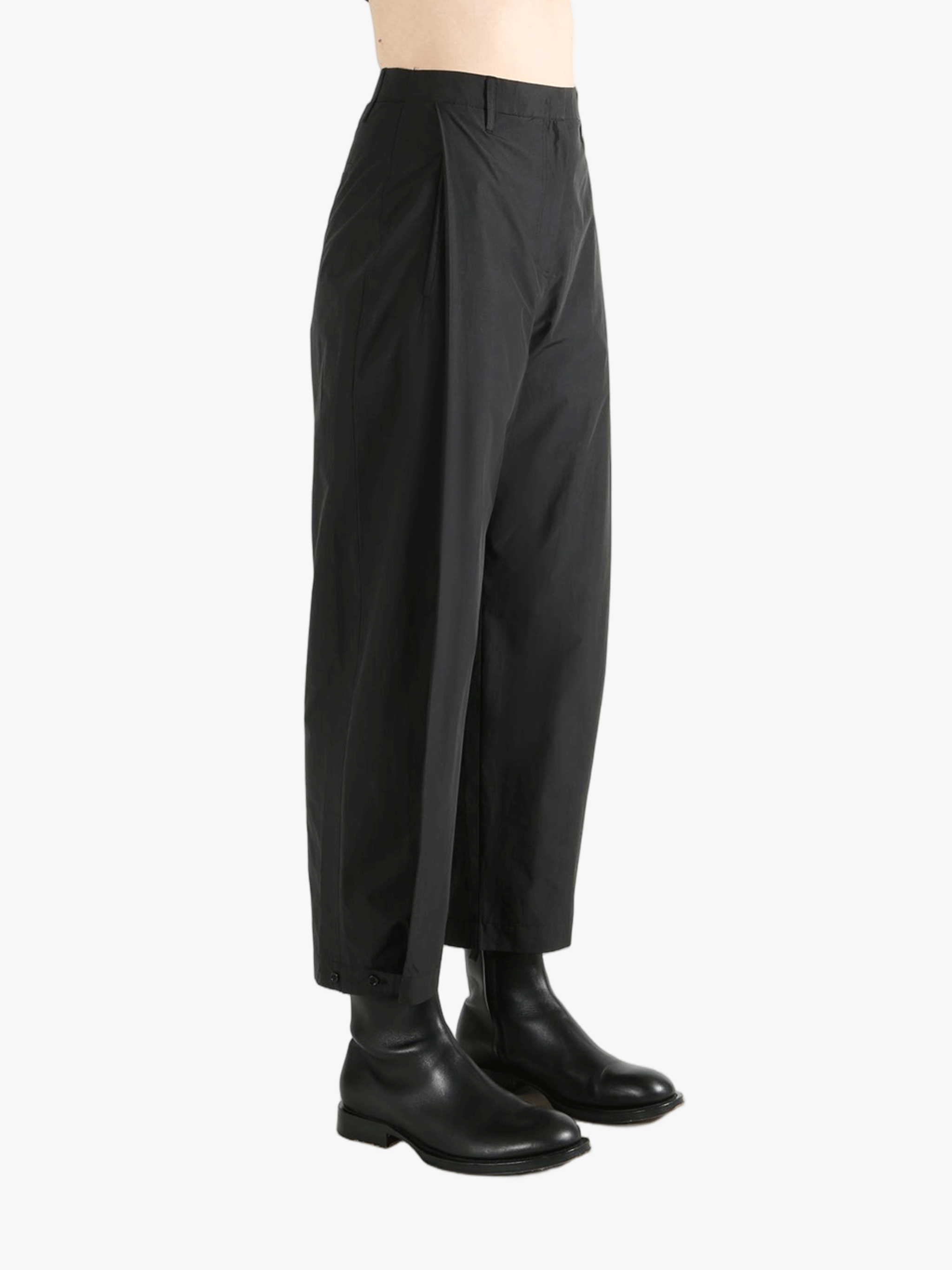 Black pants worn by a person, showing the pants fit