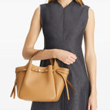 brown bags worn by a person, showing the calf Leather fit