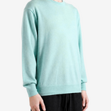 Green knitwear worn by a person, showing the knitwear fit