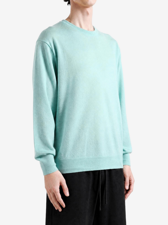 Green knitwear worn by a person, showing the knitwear fit