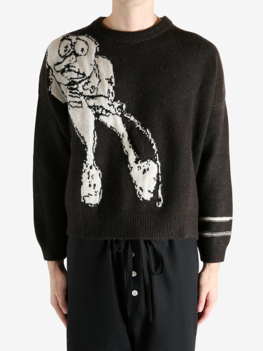 Black sweater worn by a person, showing the sweater's fit