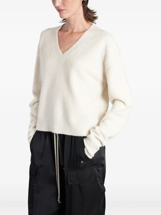 White top worn by a person, showing the top fit
