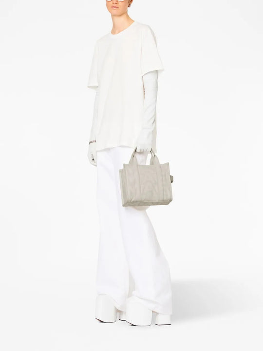 White bag worn by a person, showing the bag's fit