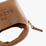 Close up of the brown bag, showing texture of the leather fabric