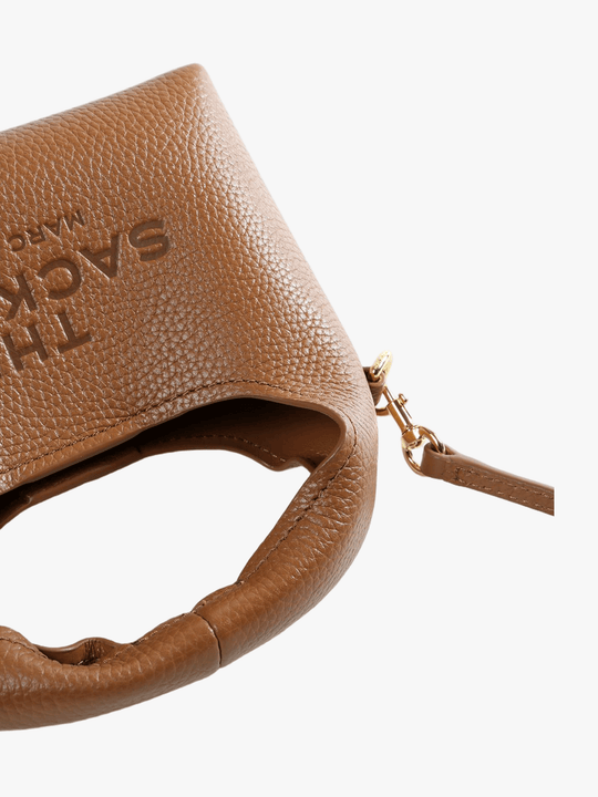 Close up of the brown bag, showing texture of the leather fabric