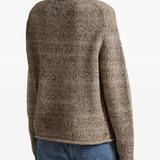 Tan sweater worn by a person, showing the sweater's fit