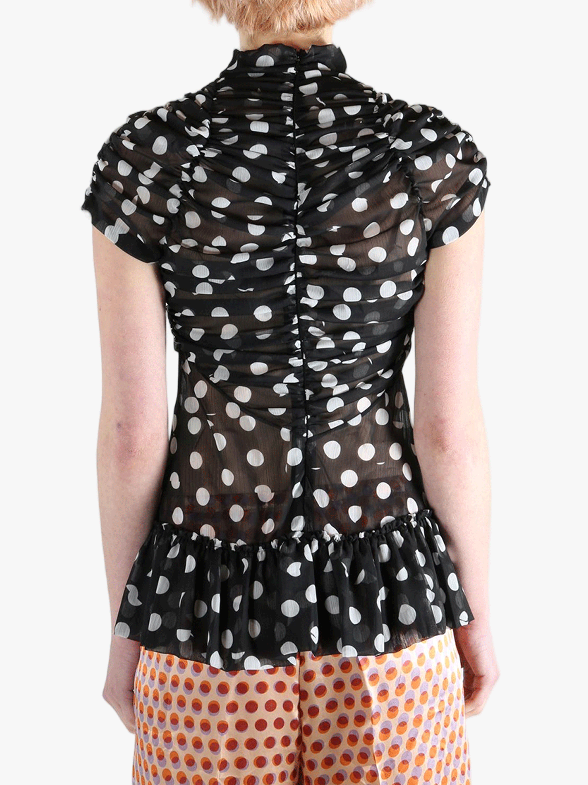 Black top worn by a person, showing the top‘s fit