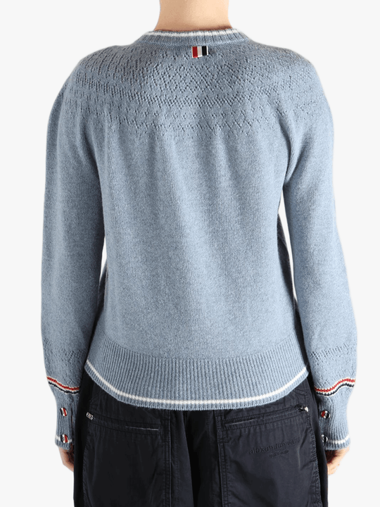 Blue cardigan worn by a person, showing the cardigan's fit