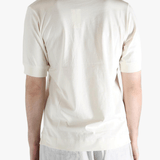 White top worn by a person, showing the top's fit