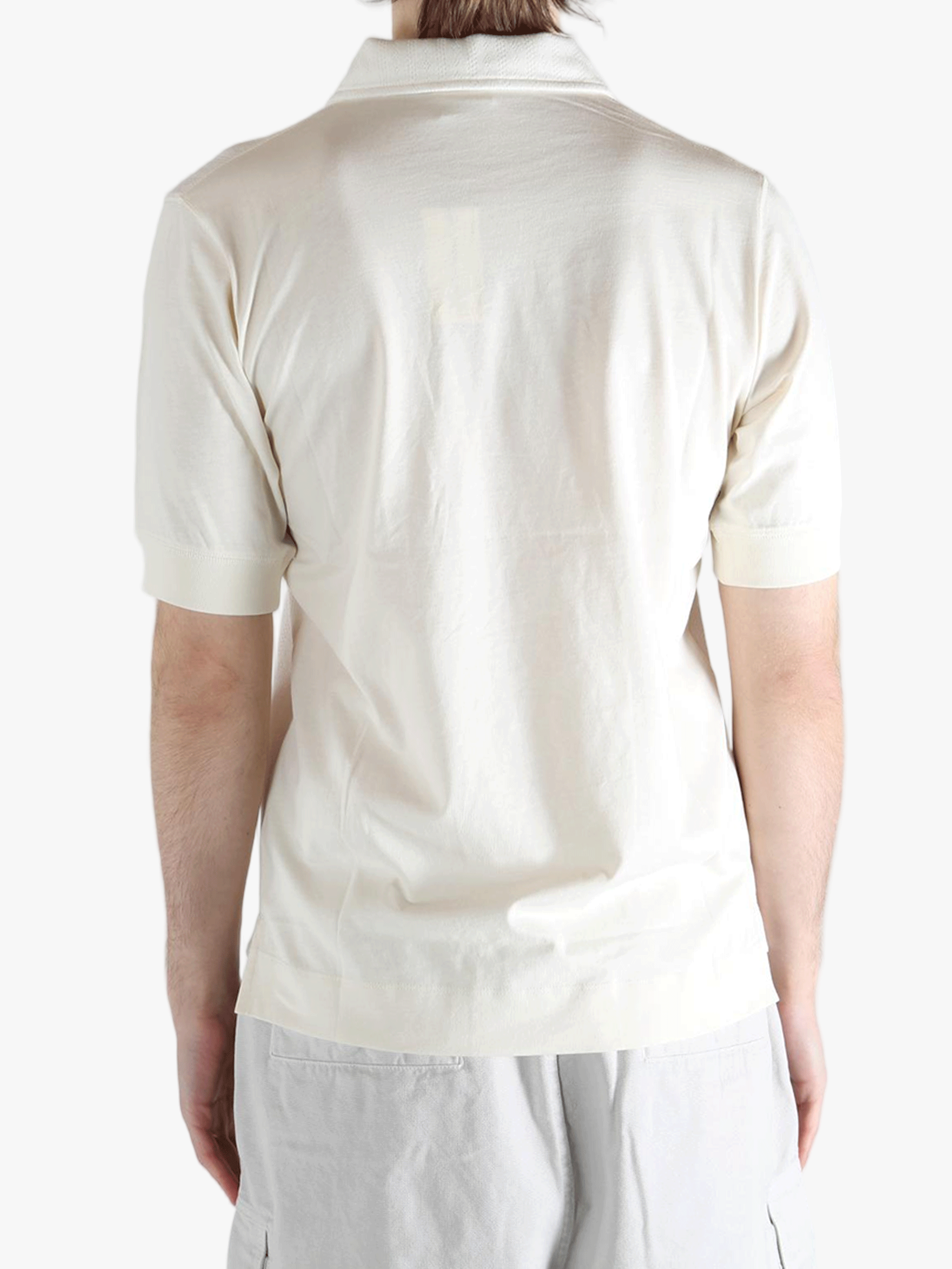 White top worn by a person, showing the top's fit