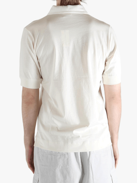 White top worn by a person, showing the top's fit