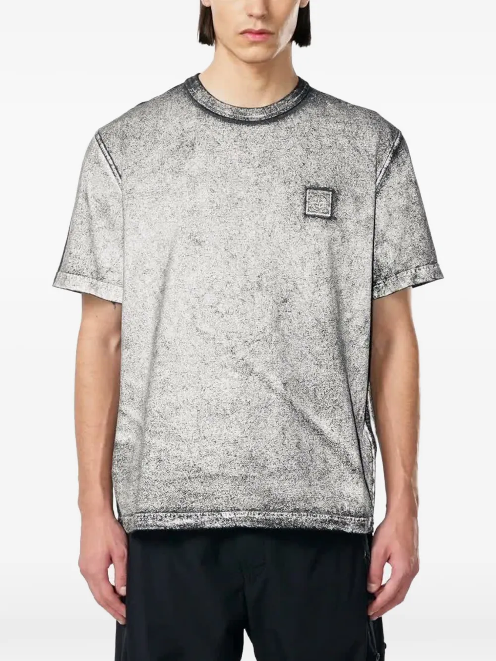 Black t-shirt worn by a person, showing the black t-shirt's fit