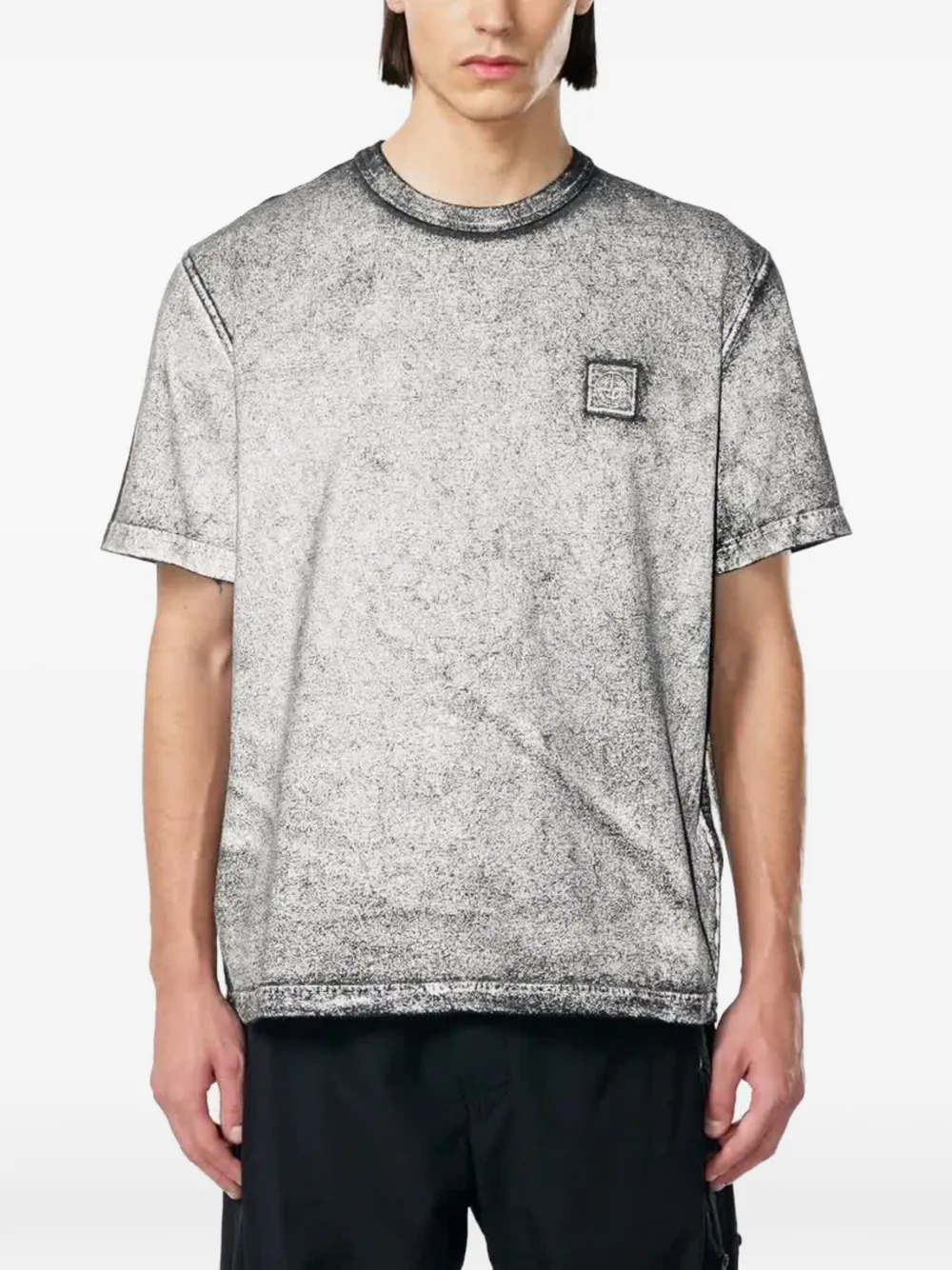 Black t-shirt worn by a person, showing the black t-shirt's fit