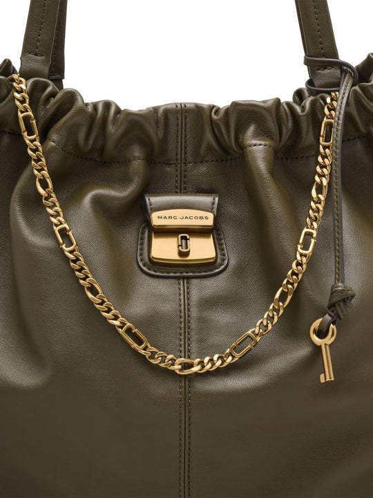 Close up of the green bag, showing texture of the leather fabric