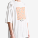 White t-shirt worn by a person, showing the t-shirt fit