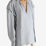 Grey blouse worn by a person, showing the blouse's fit