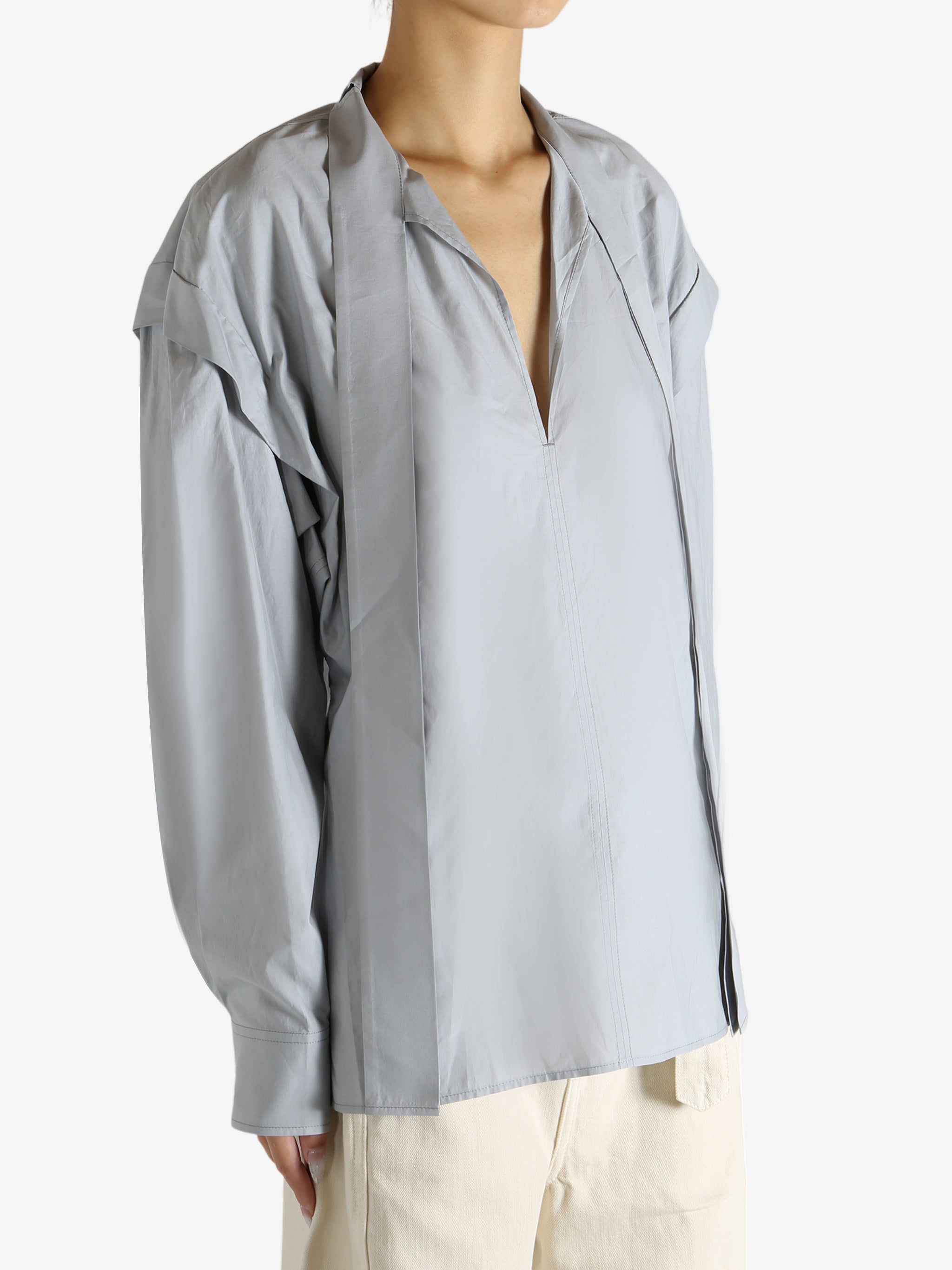 Grey blouse worn by a person, showing the blouse's fit