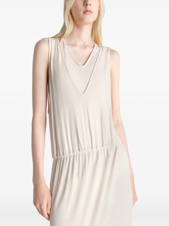 Tan dress worn by a person, showing the dress fit