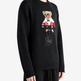 Black knitwear worn by a person, showing the knitwear fit