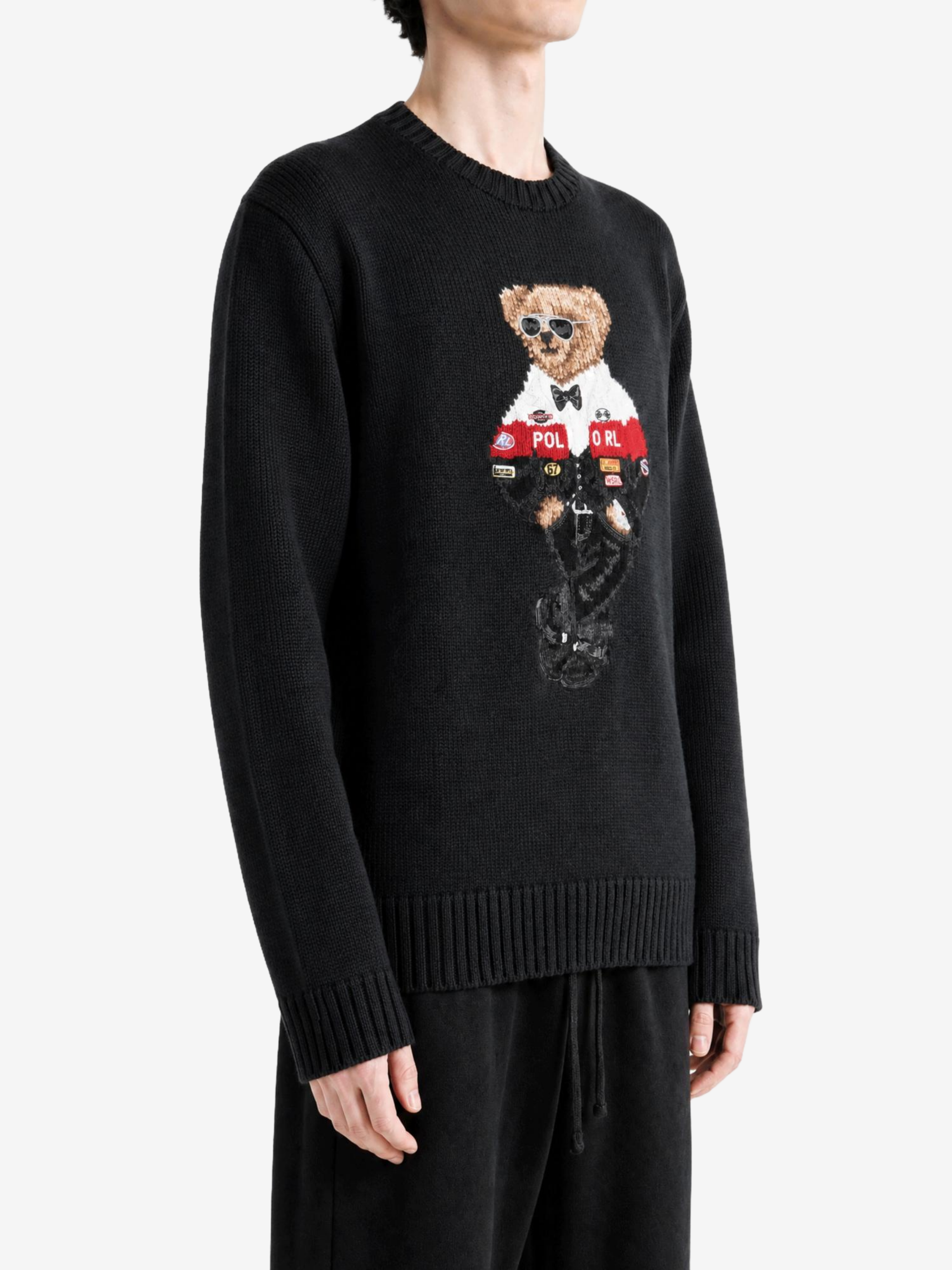 Black knitwear worn by a person, showing the knitwear fit