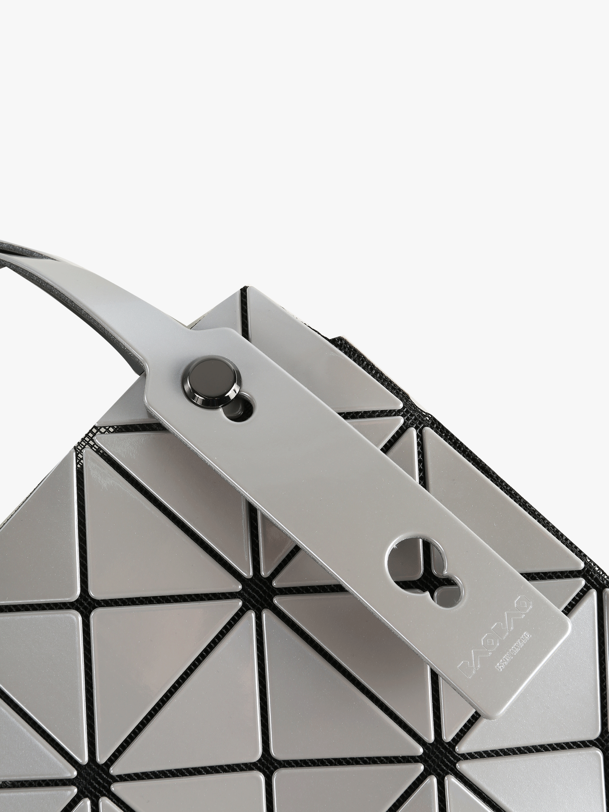 Close up of grey handbag,showing texture of the polyvinyl fabric.