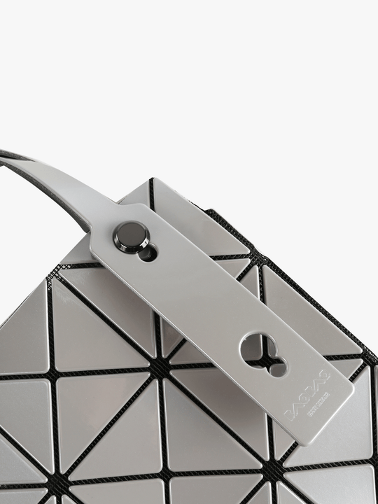 Close up of grey handbag,showing texture of the polyvinyl fabric.