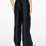 Black pants worn by a person, showing the pants fit