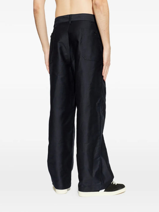 Black pants worn by a person, showing the pants fit