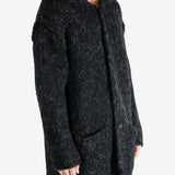 Black coat worn by a person, showing the coat's fit