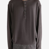 Brown long-sleeve shirt worn by a person, showing the shirt's fit