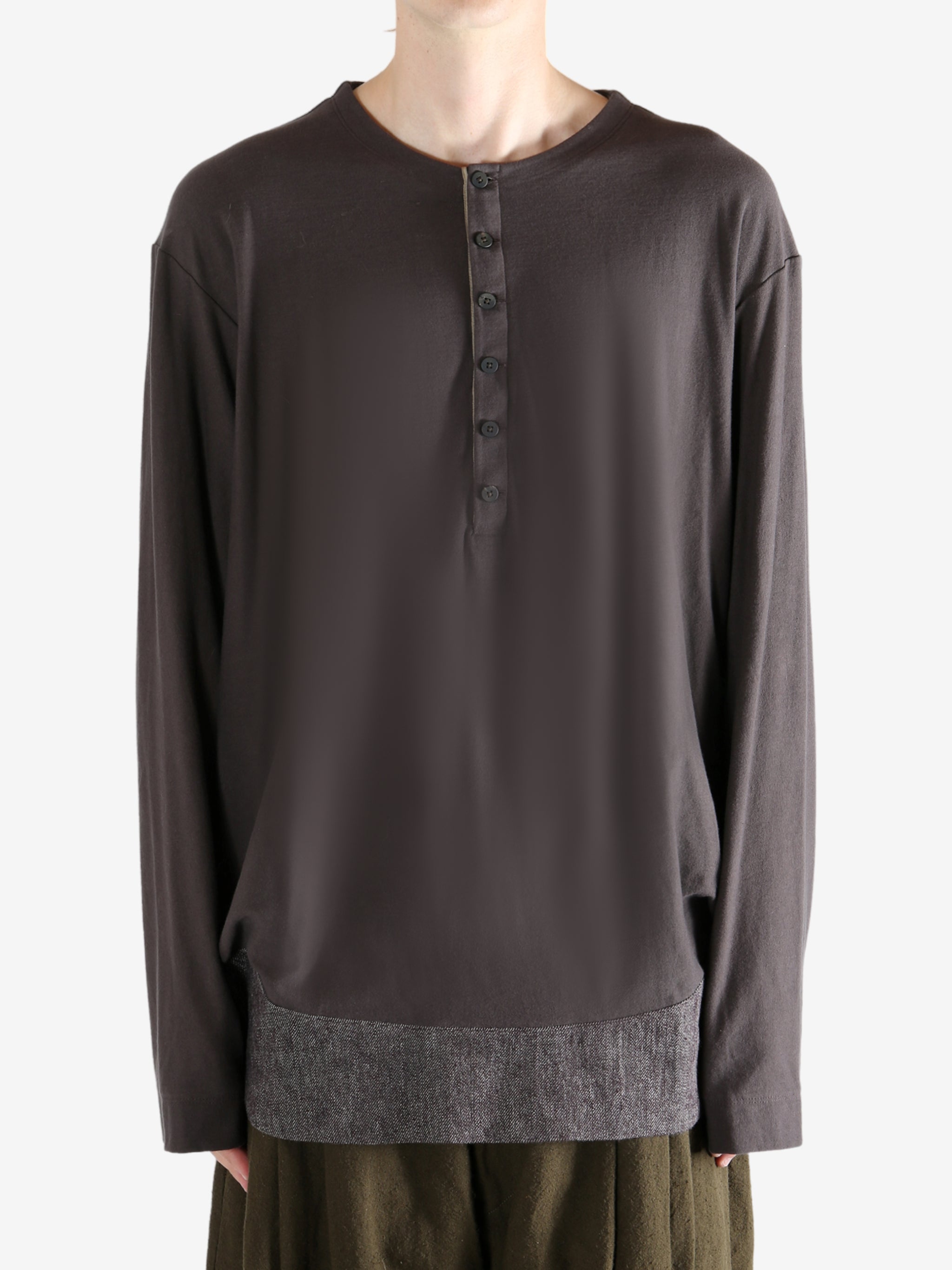 Brown long-sleeve shirt worn by a person, showing the shirt's fit