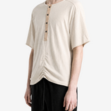 Tan t-shirt worn by a person, showing the t-shirt fit