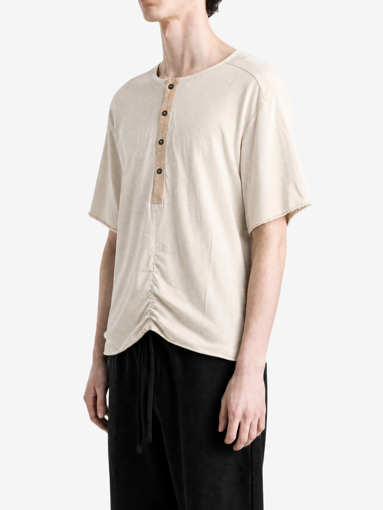 Tan t-shirt worn by a person, showing the t-shirt fit