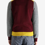 Grey knitwear worn by a person, showing the knitwear's fit