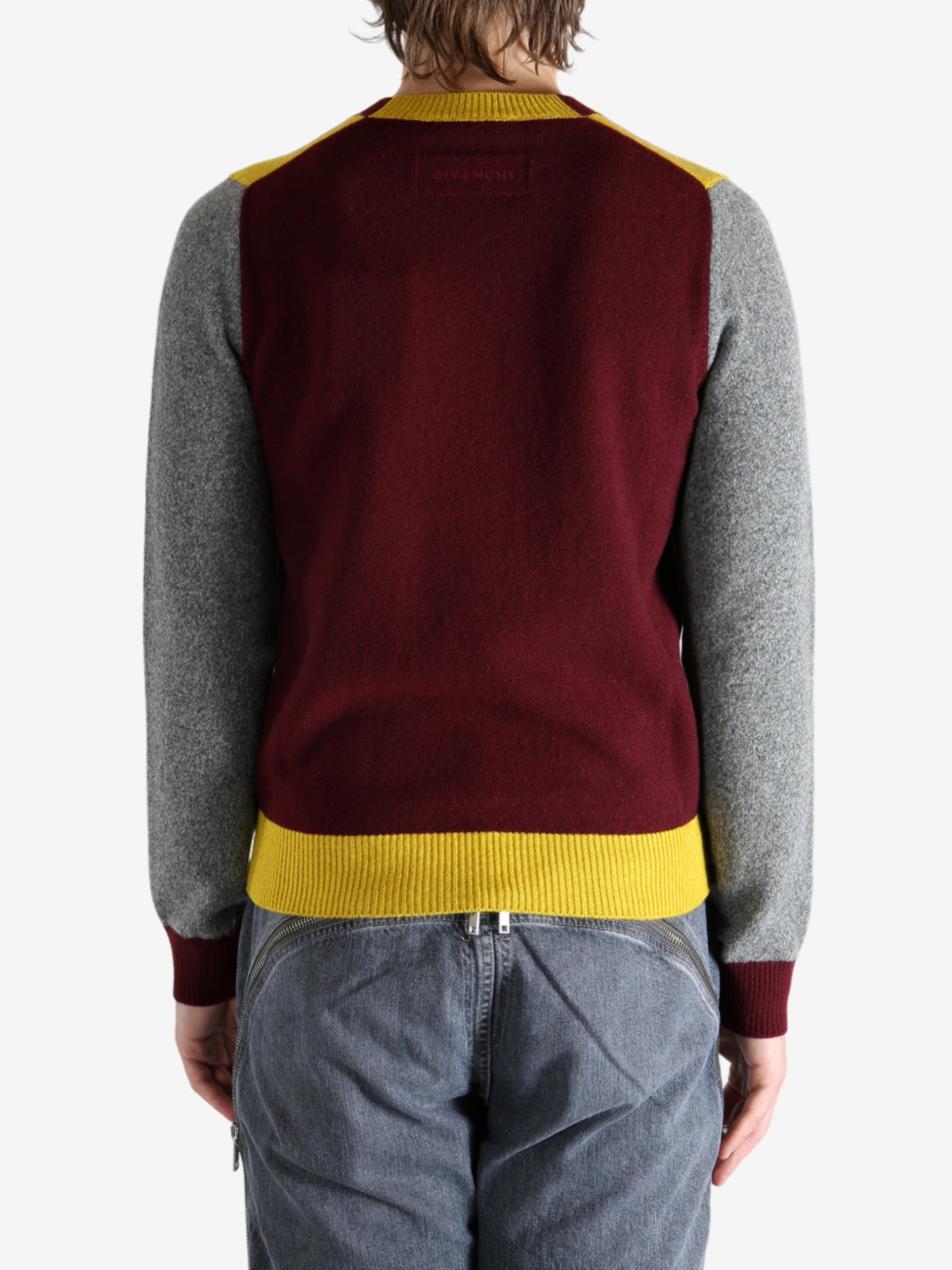 Grey knitwear worn by a person, showing the knitwear's fit