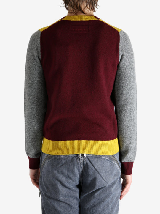 Grey knitwear worn by a person, showing the knitwear's fit